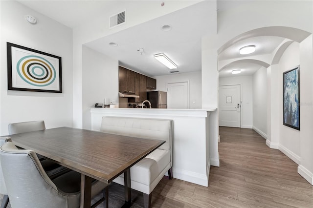 dining space with light hardwood / wood-style floors