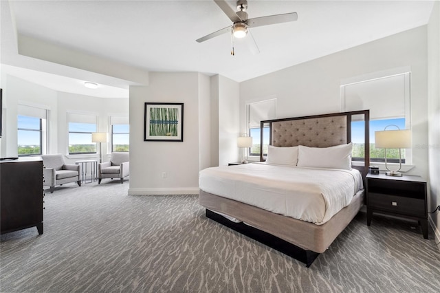 carpeted bedroom featuring multiple windows and ceiling fan