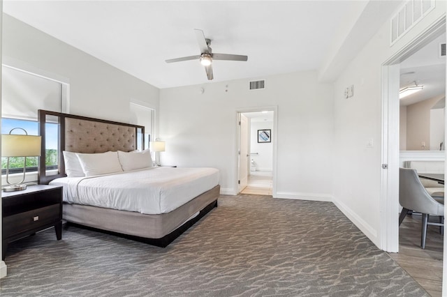 bedroom with ensuite bathroom, ceiling fan, and dark hardwood / wood-style floors