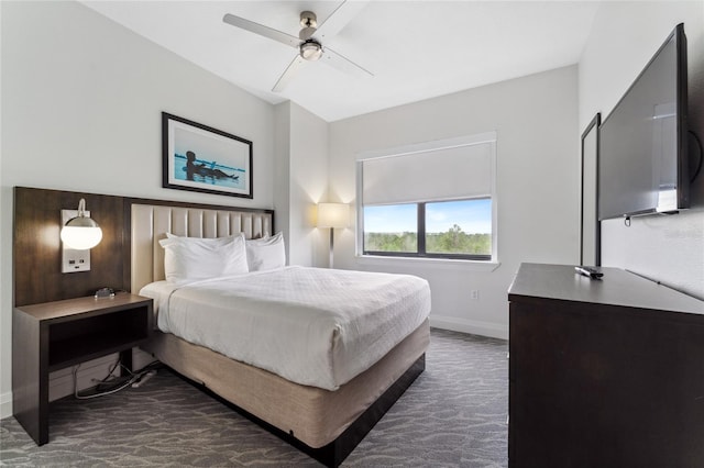 bedroom with dark colored carpet and ceiling fan