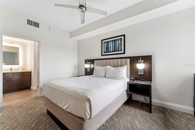 bedroom featuring dark hardwood / wood-style flooring, sink, and ceiling fan