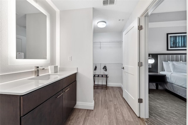 bathroom featuring vanity, a textured ceiling, and hardwood / wood-style flooring