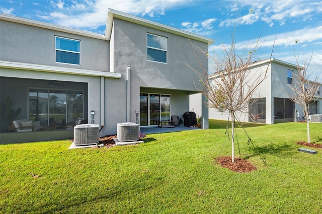 back of property featuring a patio area, a lawn, and central AC unit