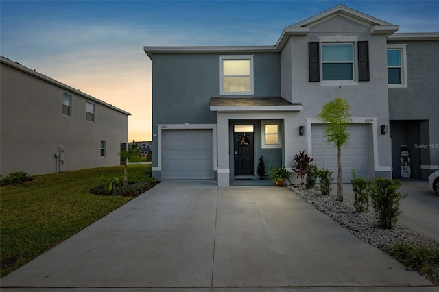 view of front of home with a yard and a garage