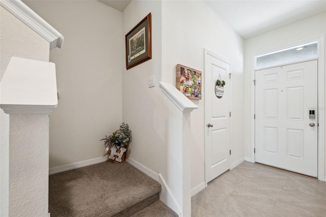 foyer with light colored carpet