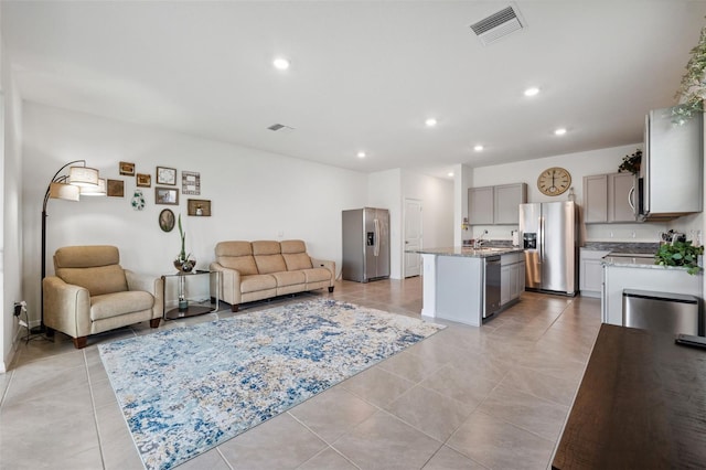 tiled living room featuring sink