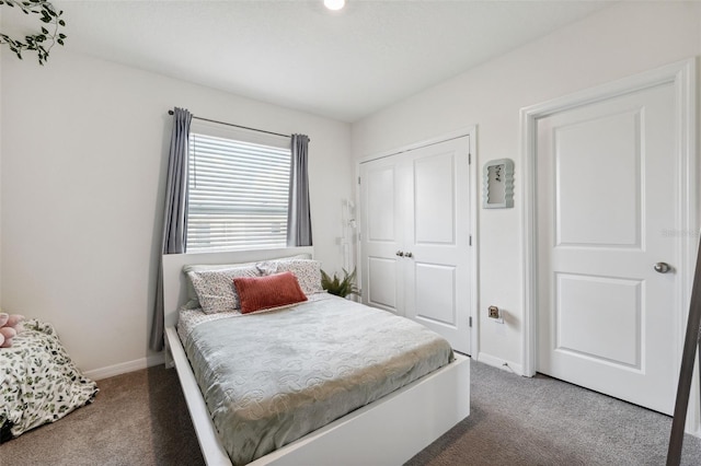 bedroom featuring a closet and dark carpet