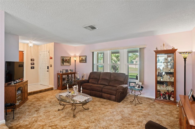 living room with light carpet and a textured ceiling