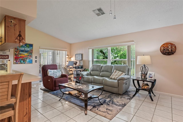 tiled living room with a textured ceiling and vaulted ceiling