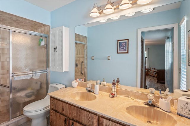 bathroom featuring vanity, toilet, and walk in shower