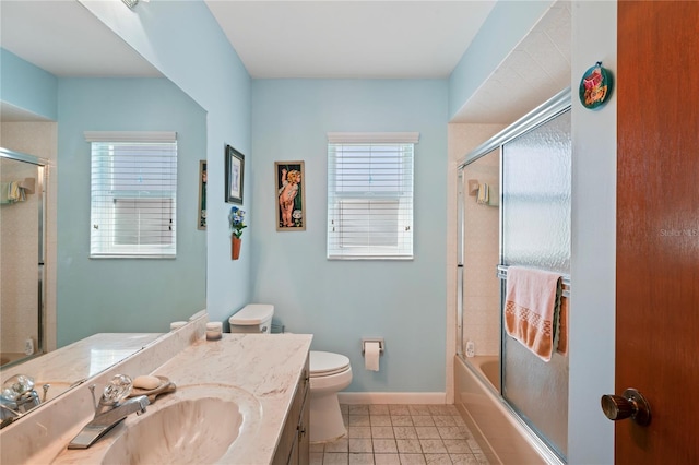 full bathroom with tile patterned flooring, vanity, toilet, and bath / shower combo with glass door