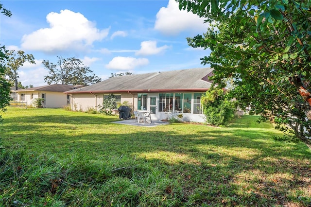 back of property with a patio and a lawn