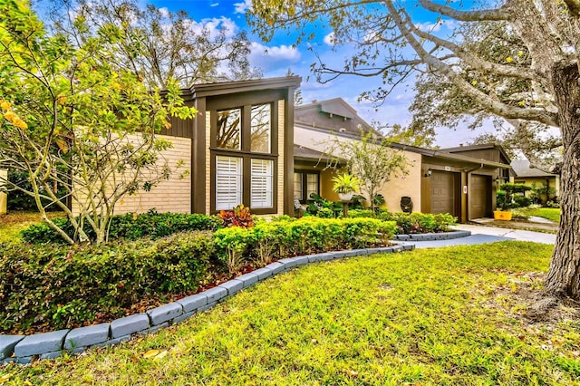 view of front of property featuring a garage and a front lawn