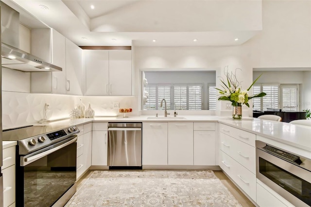 kitchen with plenty of natural light, white cabinetry, and stainless steel appliances