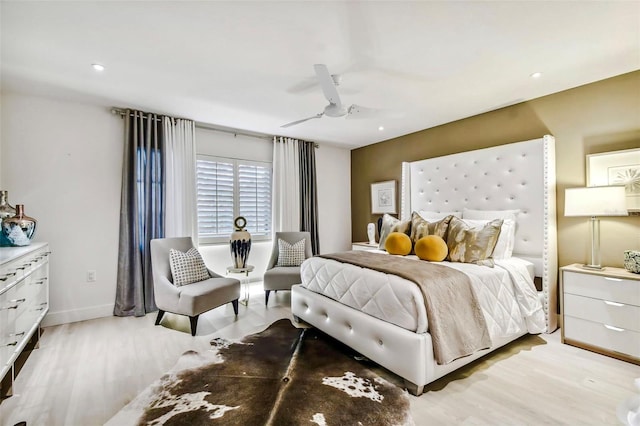 bedroom with ceiling fan and light hardwood / wood-style floors