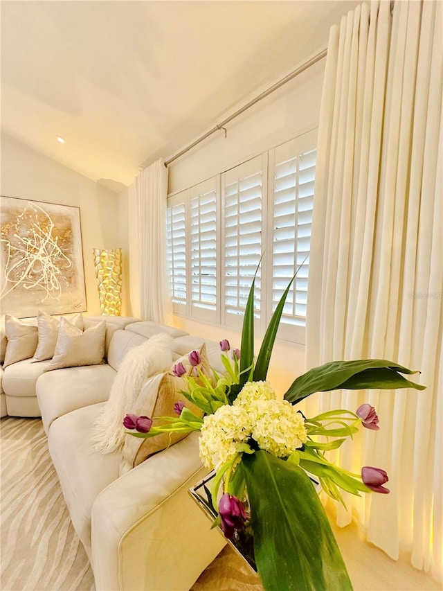 interior space featuring carpet flooring and lofted ceiling