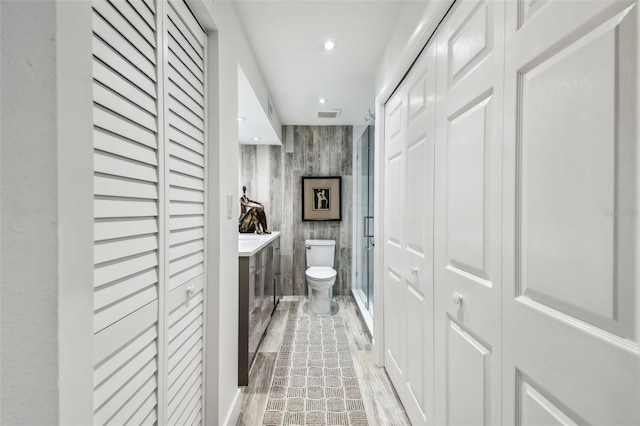 bathroom with vanity, hardwood / wood-style flooring, toilet, and walk in shower