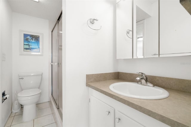 bathroom featuring vanity, tile patterned flooring, toilet, a textured ceiling, and an enclosed shower