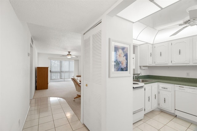 kitchen featuring white cabinets, sink, white appliances, and a textured ceiling