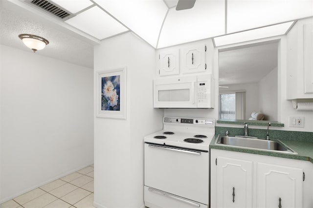 kitchen featuring white cabinetry, sink, light tile patterned flooring, and white appliances