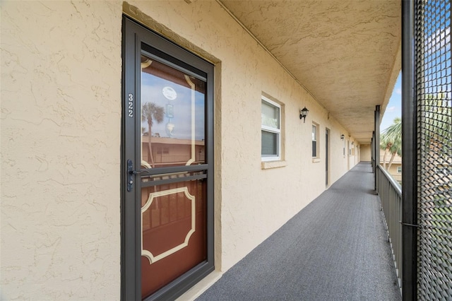 exterior space featuring a balcony and stucco siding