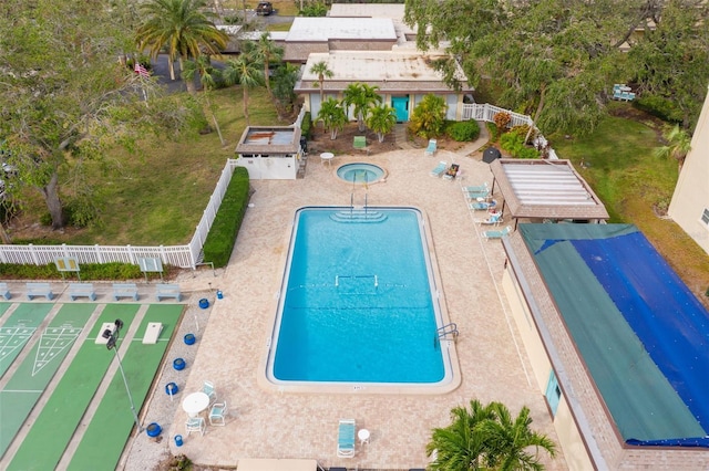 community pool featuring fence, a lawn, and a patio