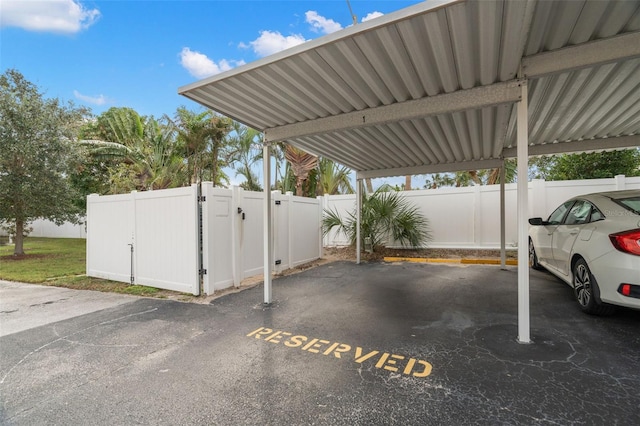 covered parking lot with fence and a gate