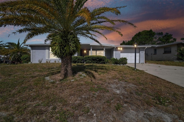 view of front of property featuring a garage and a yard