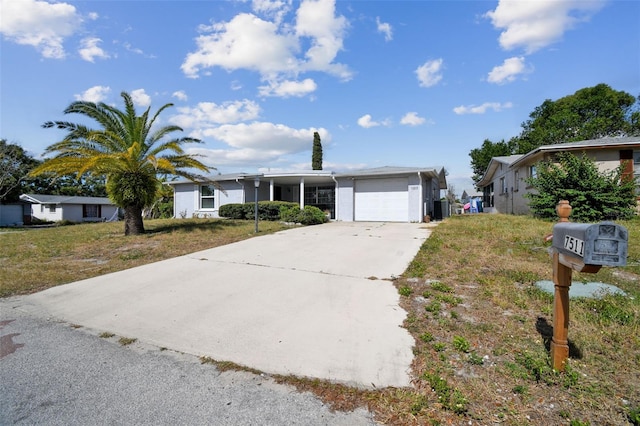 7511 Tyson Dr, Port Richey, FL 34668 - single story home featuring a garage, concrete driveway, and a front yard