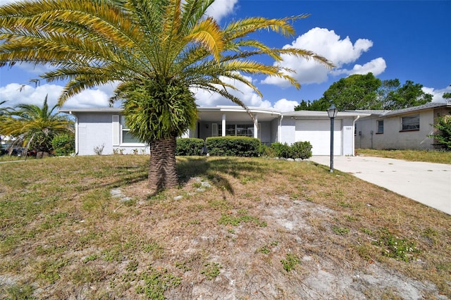 7511 Tyson Dr, Port Richey, FL 34668 - ranch-style home featuring an attached garage and concrete driveway