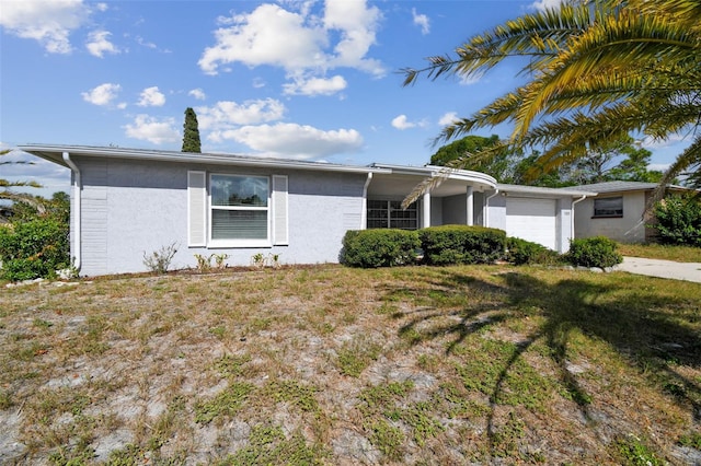 single story home with a front lawn and a garage