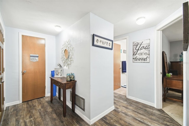 hallway with dark hardwood / wood-style flooring