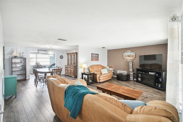 living room with hardwood / wood-style floors and a notable chandelier