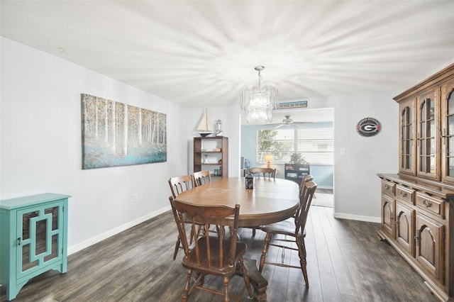 7511 Tyson Dr, Port Richey, FL 34668 - dining space with dark wood-style floors, baseboards, a ceiling fan, and a chandelier