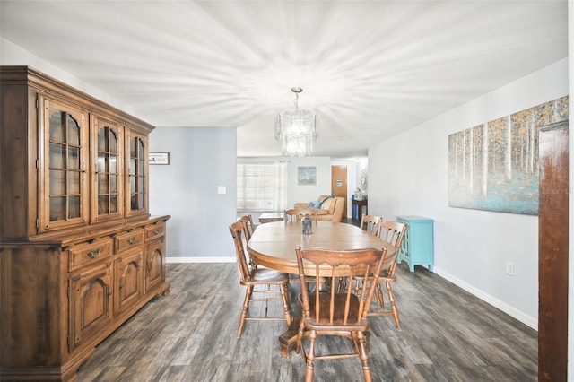 dining space with dark wood-type flooring and a chandelier