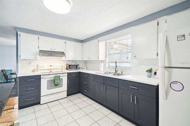 7511 Tyson Dr, Port Richey, FL 34668 - kitchen featuring white appliances, a sink, under cabinet range hood, and white cabinets