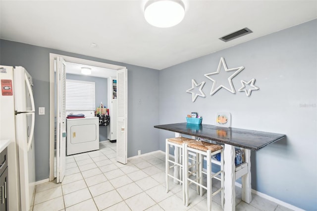 7511 Tyson Dr, Port Richey, FL 34668 - dining space featuring washer / clothes dryer, baseboards, and light tile patterned floors