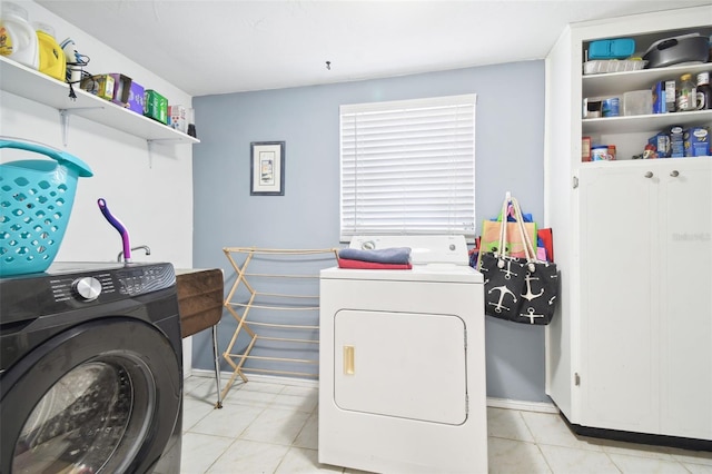 7511 Tyson Dr, Port Richey, FL 34668 - clothes washing area featuring washer and clothes dryer, baseboards, and light tile patterned floors