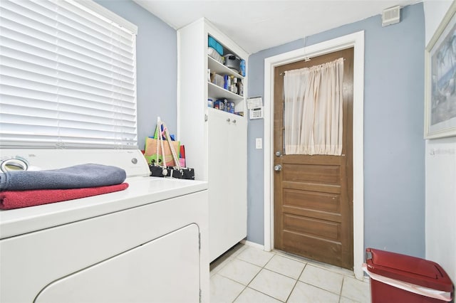 laundry room with light tile patterned floors and washer / clothes dryer