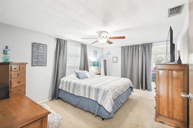 bedroom featuring ceiling fan and light carpet