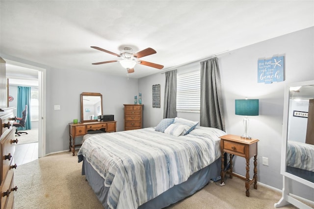 bedroom featuring light colored carpet and ceiling fan