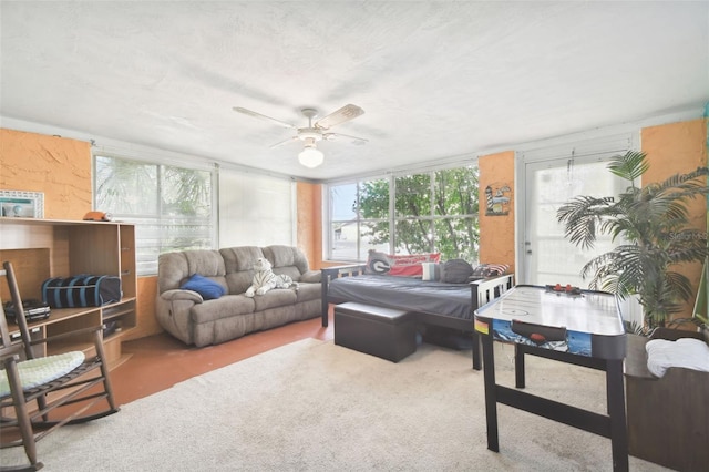 carpeted living room with ceiling fan