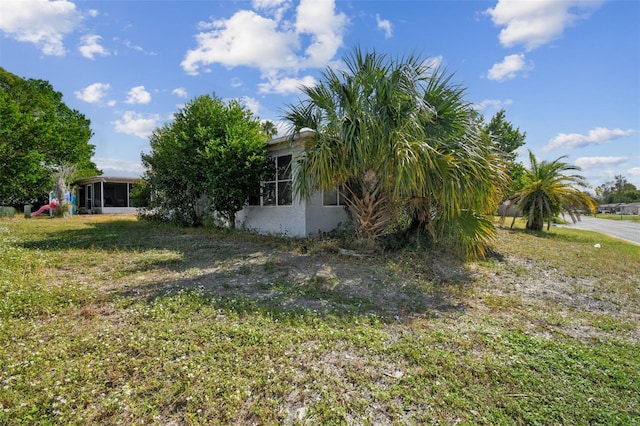 7511 Tyson Dr, Port Richey, FL 34668 - view of grassy yard featuring a sunroom