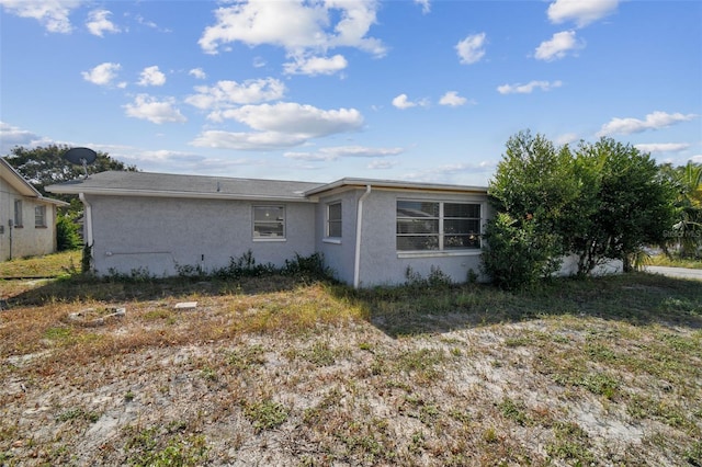 7511 Tyson Dr, Port Richey, FL 34668 - rear view of house with stucco siding