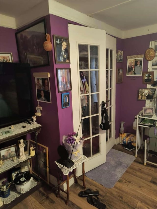 interior space with ornamental molding and hardwood / wood-style floors