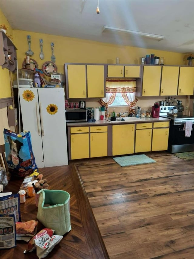 kitchen featuring stainless steel appliances, dark wood-type flooring, and sink