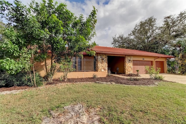 view of front of house with a front yard and a garage