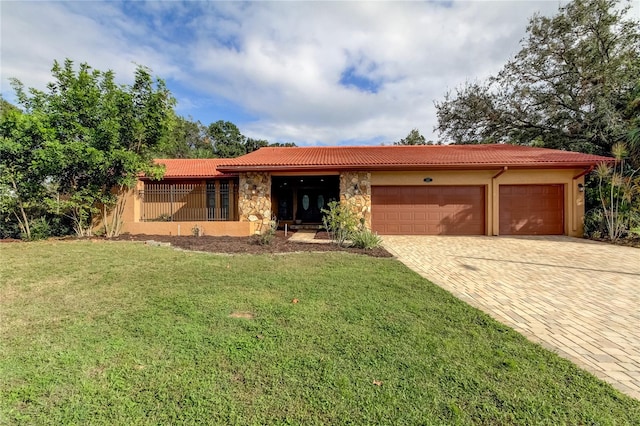 ranch-style house with a garage and a front yard