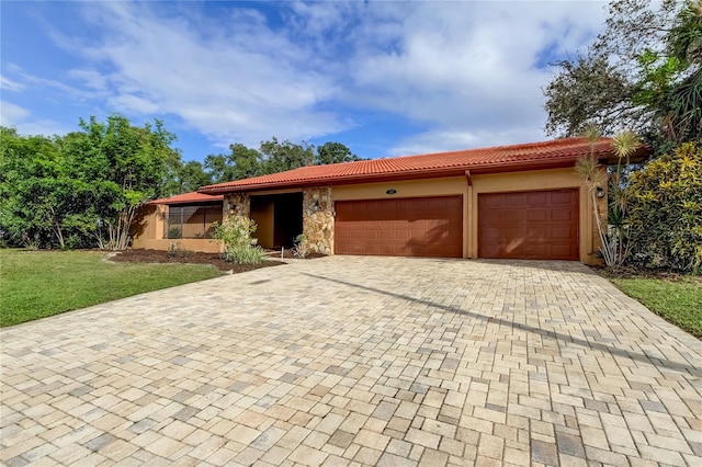 view of front of house with a garage and a front lawn