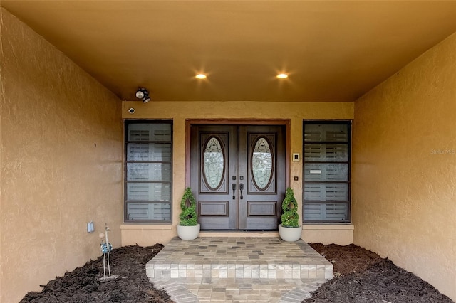 view of exterior entry with covered porch